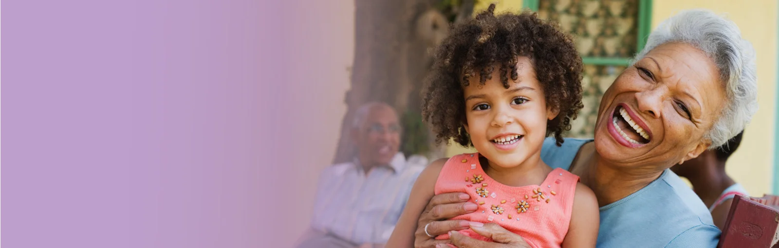 elderly woman holds granddaughter on lap